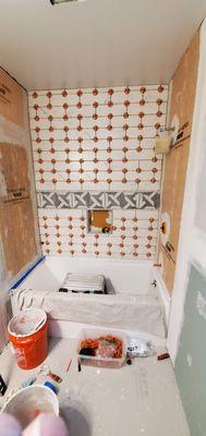 Installing a new bath tub and tile surround.