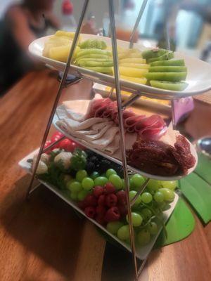 Fruit tray with various meats and cheeses for a party of 4