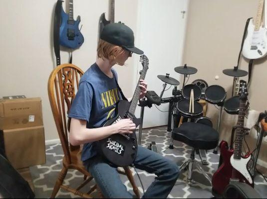 This is one of my students who is working madly to form a punk rock band.  Here he is recording one of the songs he has learned.