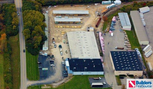 Building materials supplier Builders FirstSource's forklift is moving wood roof trusses.