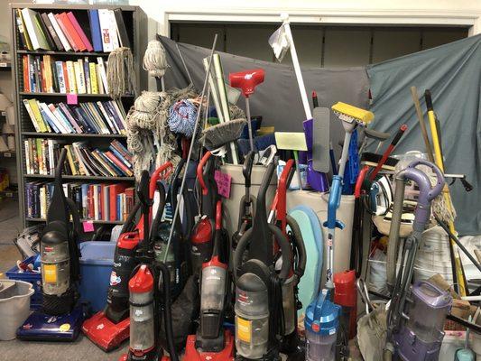 All sorts of vacuums, mops, and brooms and books galore!