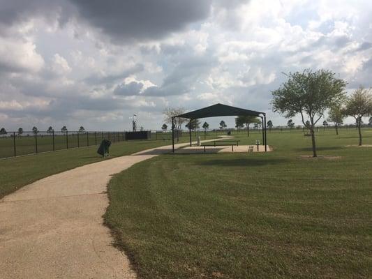 Shaded area while you sit and watch your dogs play. Water fountain for humans and pups... Kids said the water was hot