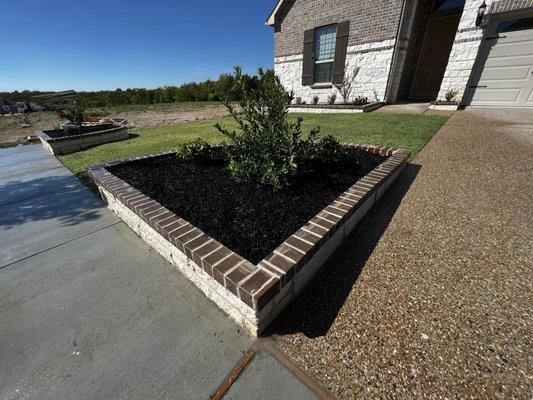 Custom brick and stone flowerbed !