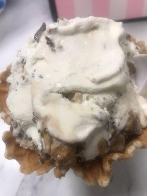 Vanilla ice cream in a waffle bowl, Heath bar and Reese's peanut butter cup mixed in.