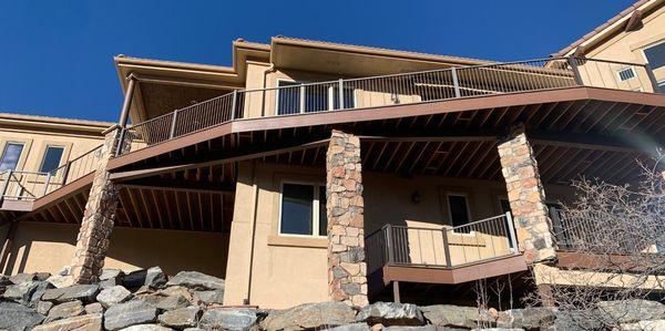 Large house with two-levels of composite deck with cable railing maximizes the mountain view.