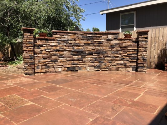 Decorative wall using stone veneer for outdoor living area.