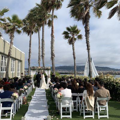 My wedding was an outdoor by the beach. Look at the beautiful arch, runner, and the flowers on the aisle chairs!!