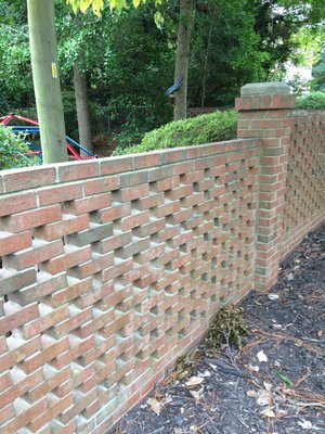 brick fence repair caused by fallen tree