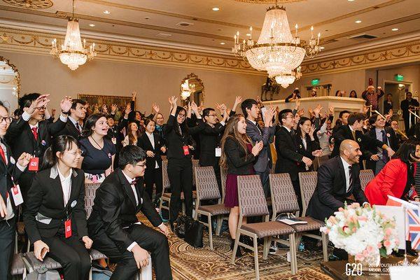 Students celebrate during the Model G20 Summit awards ceremony.