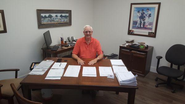 Robert E. Wells at desk