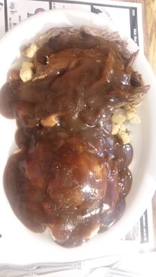 The roast beef smothered in gravy still tasted bland the stuffing underneath was just bread crumbs with no seasoning.