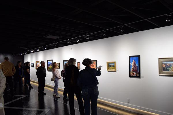 Guests viewing artwork in the Kephart Gallery during a First Friday opening reception