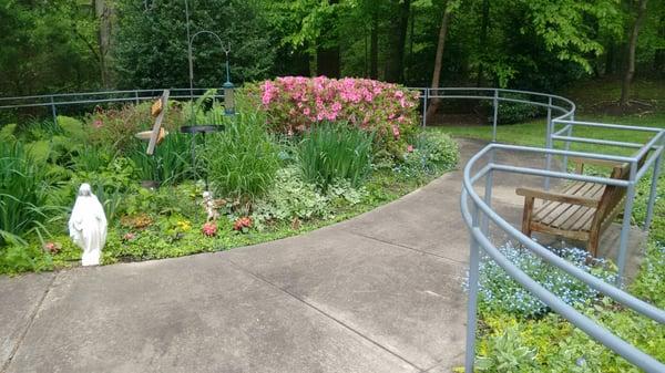 Tranquil patio with walking path surrounded by nature.