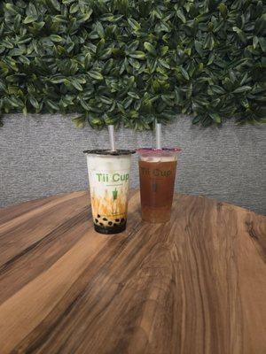 Brown tea bubble tea and lychee tea with popping bubbles.