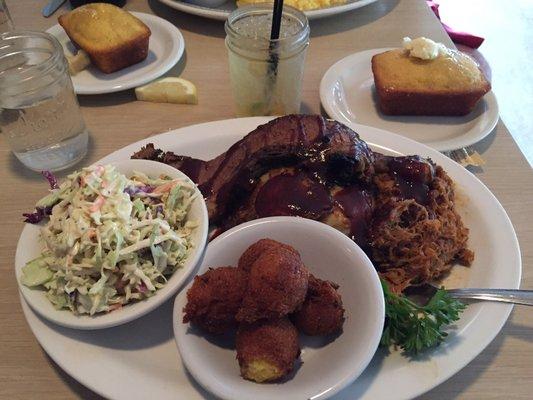 Combo plate of pulled pork, chicken, brisket, hush puppies, coleslaw, cornbread, and mint julip