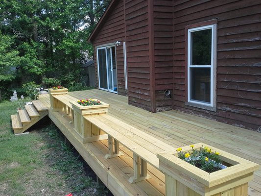 Deck after with built in planters and benches.