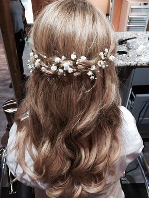 A half updo with added baby's breath to match the brides wedding flowers.