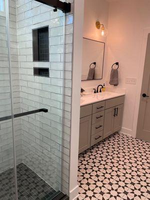 Options include ceramic tile and glass shower doors. The vanity has plenty of usuable storage.