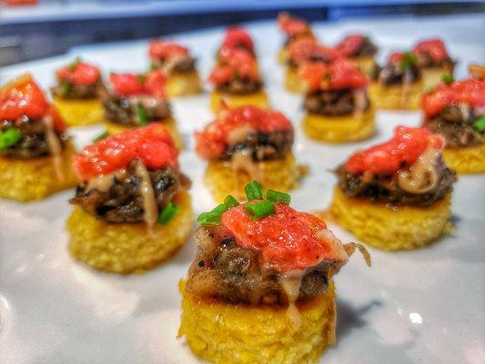 Vegan Canape. Polenta, tomato confit, black garlic, tahini, roast egg plant, pomegranate molasses.