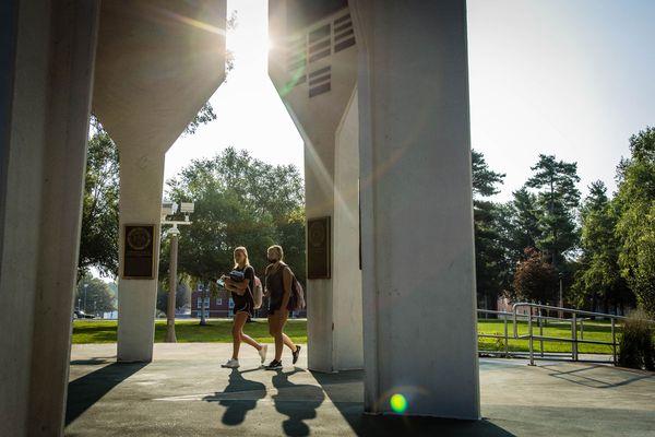 Students walking through the Memorial Bell Tower.