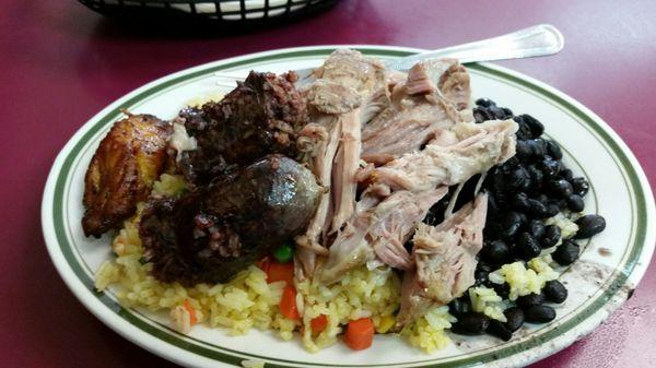 Lunch, yellow rice, black beans pernil and morcelia (blood sausage) and maduro.