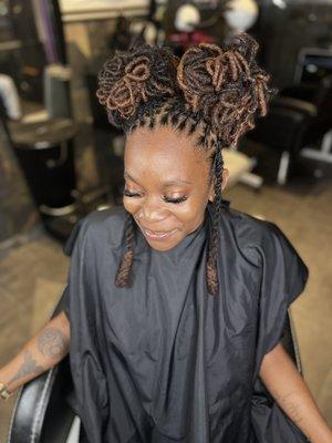 Retwist, long Locs , styled into Petal bun with hanging sides