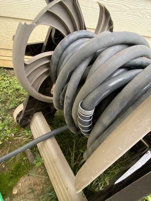 Water hose at car wash station, also does not have a spray nozzle.