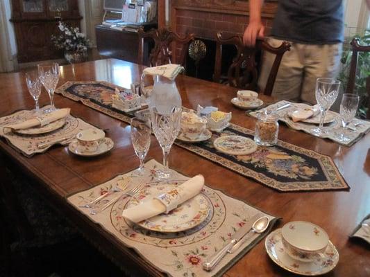 Beautiful dining room. The house is full of period antiques right down to the dishes, linens and flatware.