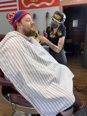 Kristy trimming my husband's beard. We were nervous about COVID so she booked him after everyone so it would be just us!