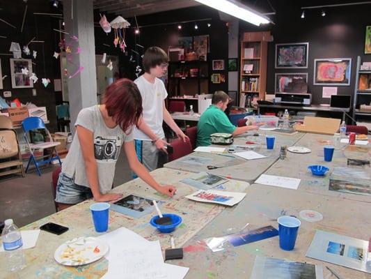 Participants in the Art Access Teen workshops make image transfers during a class taught by artist Stephanie Swift.