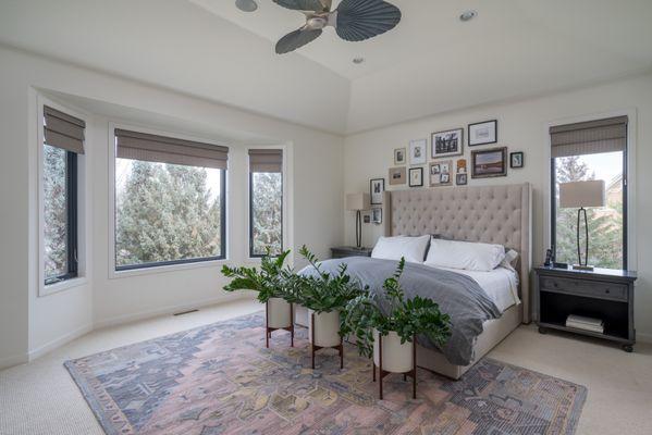 Roman shades provide a classic but modern look in this beautiful bedroom.