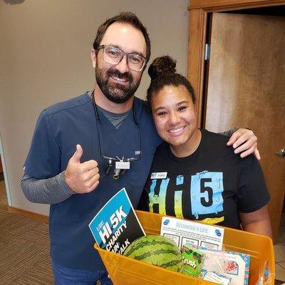 Dr. Cody with a gift from Hi 5 Orthodontics!