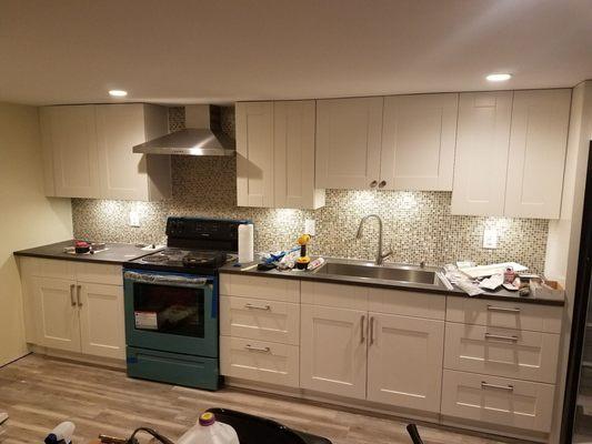 This is the kitchen from below wholesale flooring. All wood, on particle board and slow closing hardware.