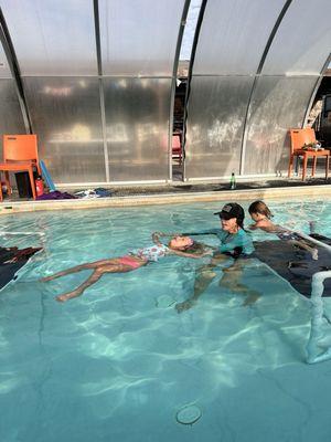 Thanks to Miss Kris my daughter  swims, rolls to her back for air and then rolls back to continue to swim in our community pool.