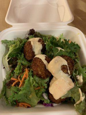 Crab cakes on a bed of salad.