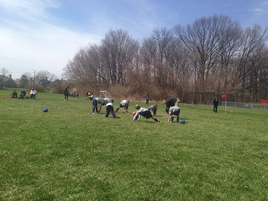 Stretching for the first game is the season! Woot woot! It's dry and sunny! #soccer2014