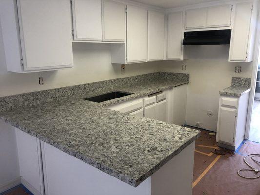 Final installation of quartz countertop with 6" backsplash