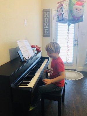 My son playing piano for the first time