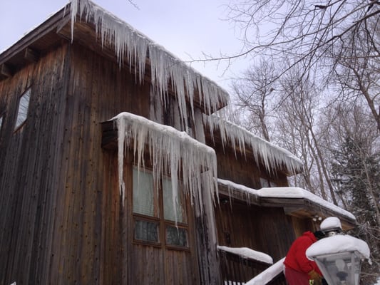 Shoveling ice and snow off the roof to prevent damage!