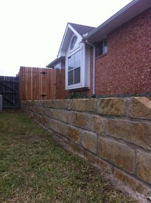 We replaced the old R/R ties and constructed this new stone wall atop a steel reinforced concrete footing...