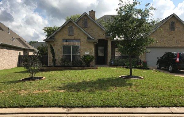 AFTER - Installed sandstone flowerbed and tree well edging, added bed mix, new plants, and mulched flowerbeds and trimmed up existing plants