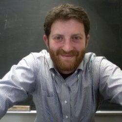 An ATX Test Prep instructor in his natural environment. In front of a chalkboard.