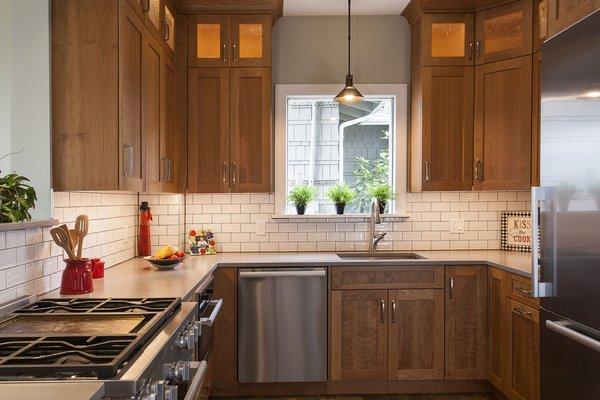 Beautiful Cherry Craftsman kitchen with subway tile and a ceiling mounted hood to keep views open