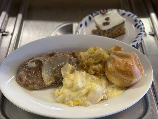 Smothered steak, cheesy potatoes, squash casserole, and carrot cake