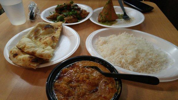 Chicken korma, chicken kabob, garlic naan, and vegetable samosa