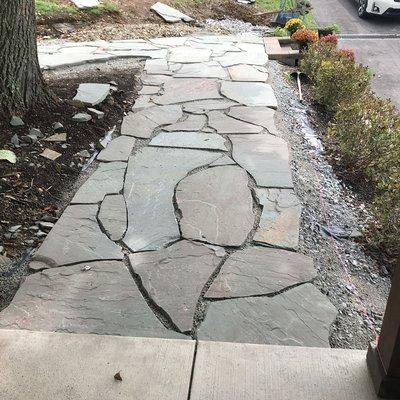 Flagstone walkway installation under way.