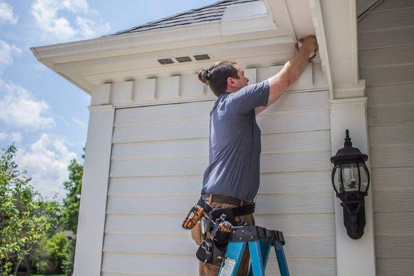 A Gillmore Security technician installing equipment.