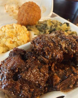 Oxtails, macaroni and cheese, collard greens and cabbage mix