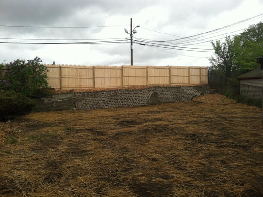 After photo, after cleaning up backyard, removed 4tons of rubbish, rebuilt wall using the same stones, topped with new fence