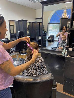 My 5 year old getting her hair done with sparkles, by Erika.